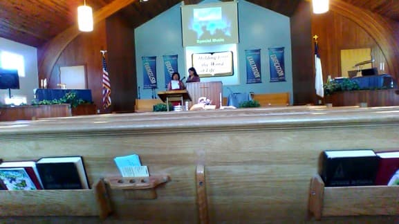 The sanctuary at Berkshire Hills Baptist Church during a service, seen from the pews.